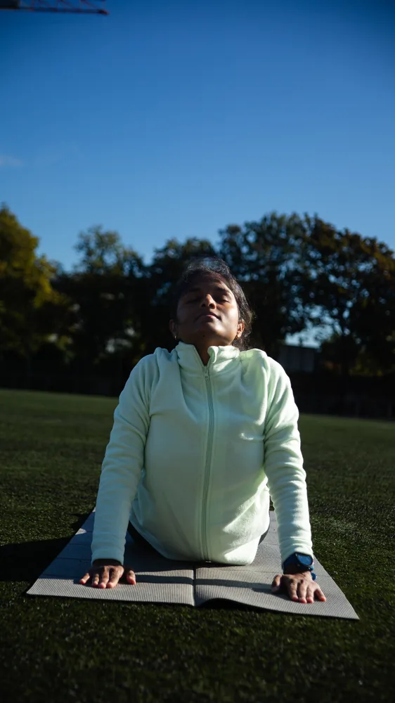 Jeevana in cobra pose, eyes closed