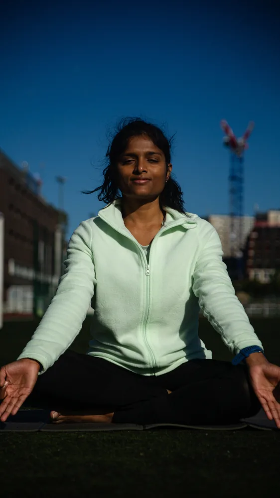 Jeevana seated, smiling